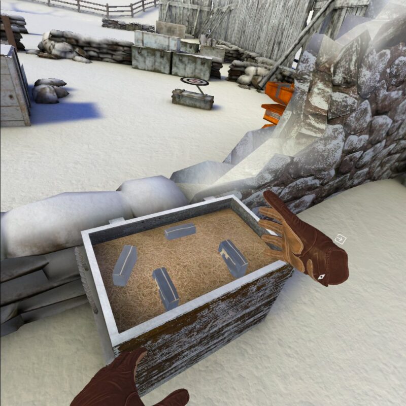 Gameplay of Winter Warrior showing the player examining a crate with objects in it. There is a small compass icon by the players right hand, and a square with an arrow pointing into it further to the right.