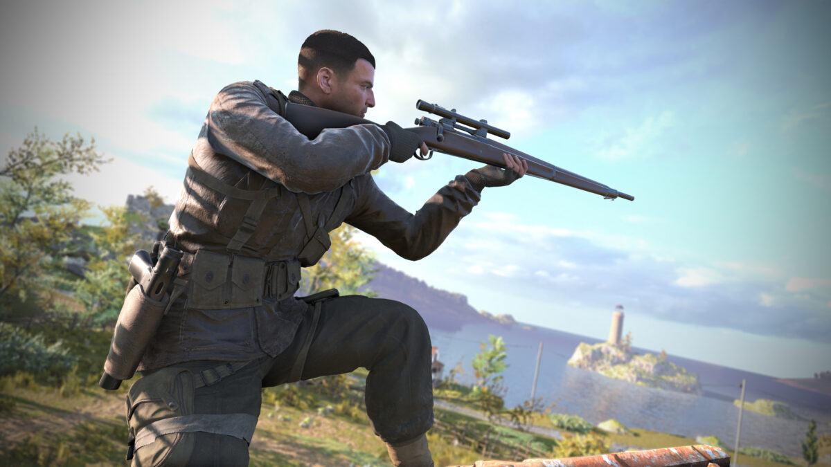 Karl Fairburne kneels whilst looking down the scope of his sniper rifle. In the background a lighthouse can be seen on an island out at sea.
